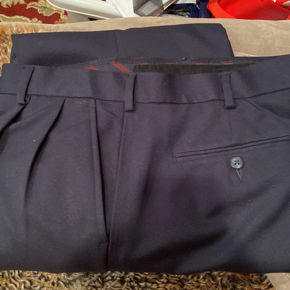 Men’s dress pants. By Van Heusen in navy. Pleated with bottom cuffs